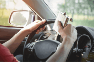 an image of someone drinking and driving