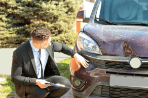Insurance adjuster inspecting car damage. Personal Injury Lawsuit.
